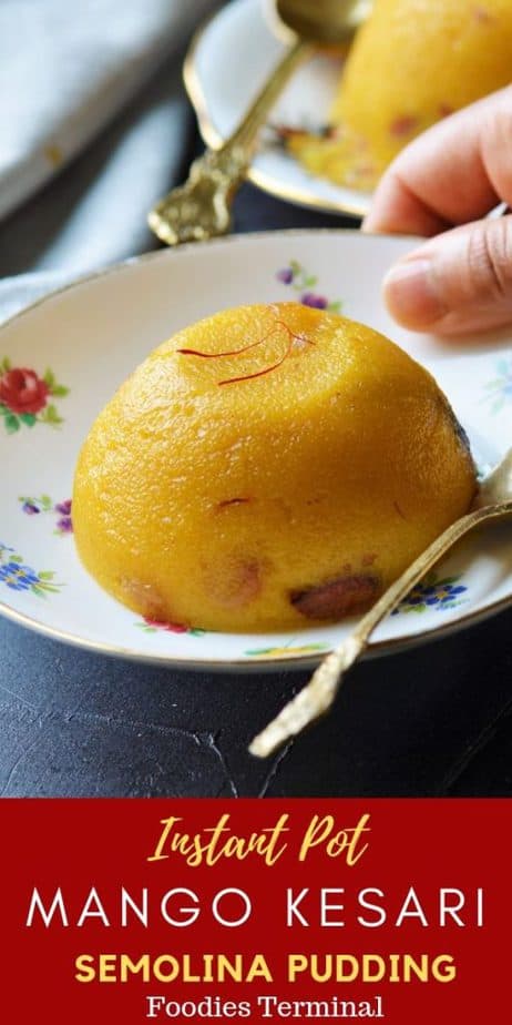 Mango semolina pudding or mango kesari on a floral plate with a sppon