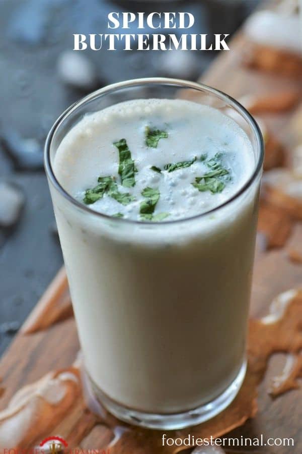 Masala Chaas with chopped coriander in a tall glass