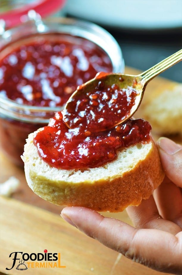 Strawberry Chutney being spread on a baguette piece
