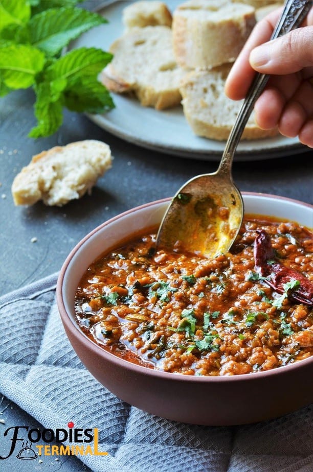 Pakistani chicken keema in a bowl with a dipping spoon