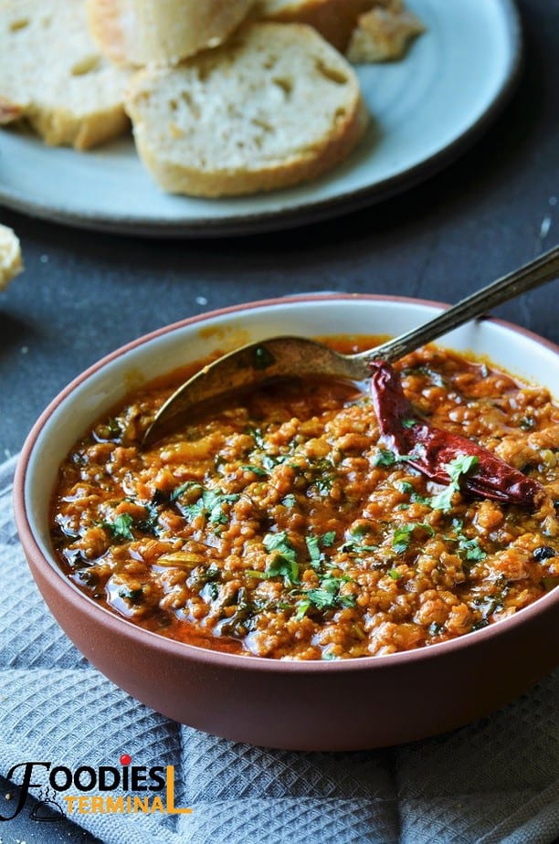 Juicy Hyderabadi chicken keema in a bowl with a red chili