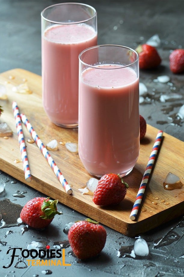 Strawberry Lassi in two glasses with straws by the side