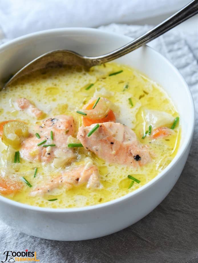 Fish Chowder with Salmon in a white bowl & a spoon