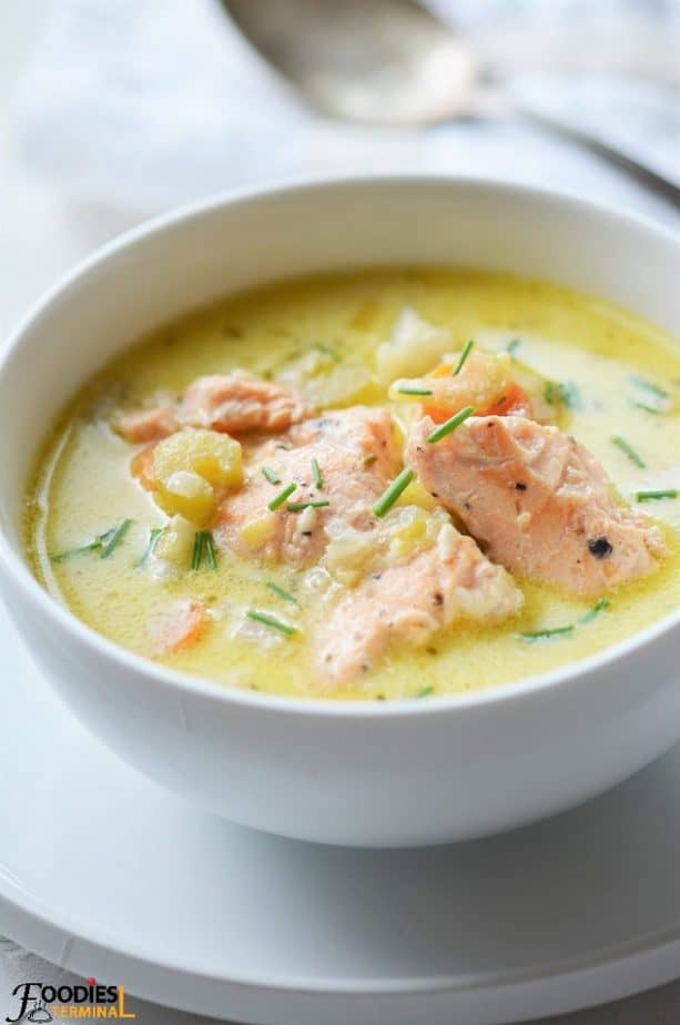 Alaskan Salmon Chowder in a white bowl on a plate