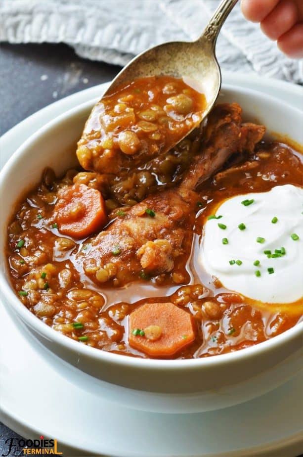 Pressure cooker Chicken Lentil stew being lifted with spoon