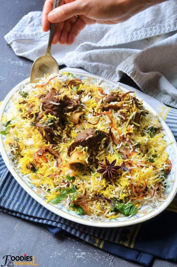 Dum Mutton Biryani recipe being lifted with spoon