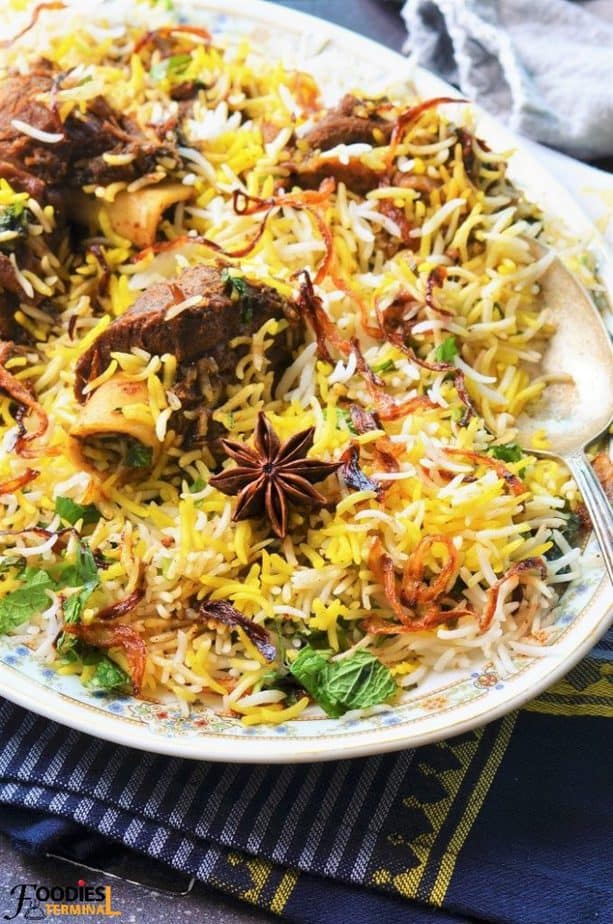 Indian Mutton Biryani opped with birista & a spoon