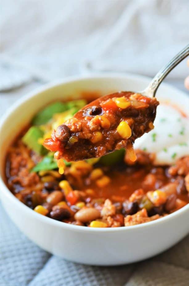 Healthy Black bean turkey chili being lifted with spoon