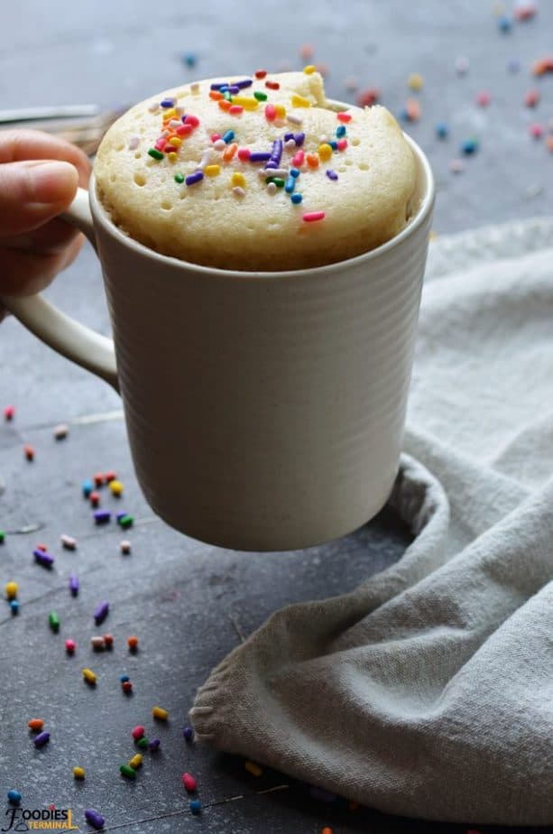 Vanilla mug cake no egg recipe in a mug with sprinkles on top