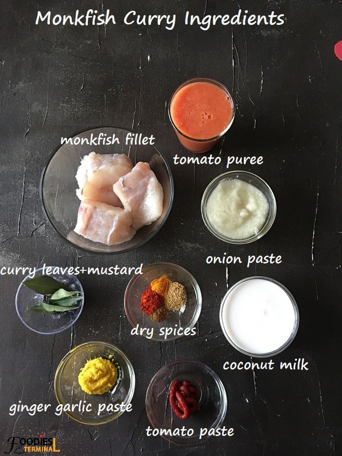 Indian style monkfish curry ingredients in bowls on a black surface