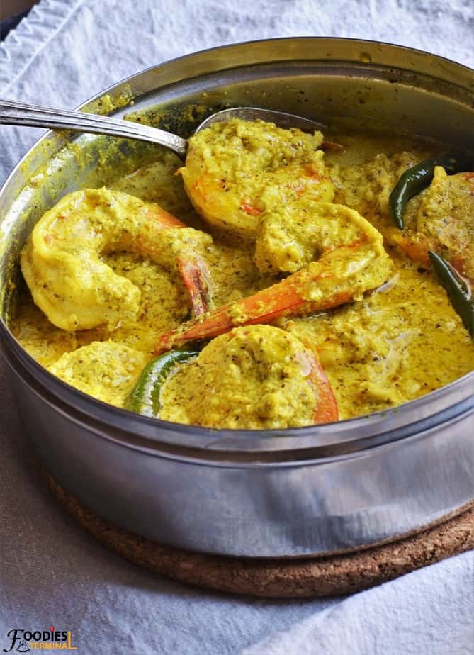 Chingri Bhapa Bengali recipe in a steel box with spoon