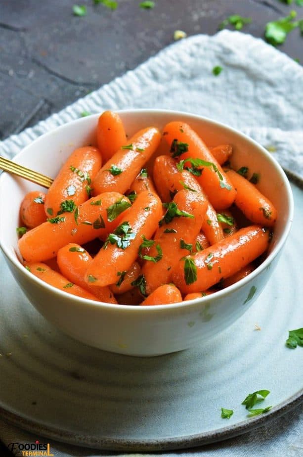 Instant Pot carrots in a white bowl kept on a plate