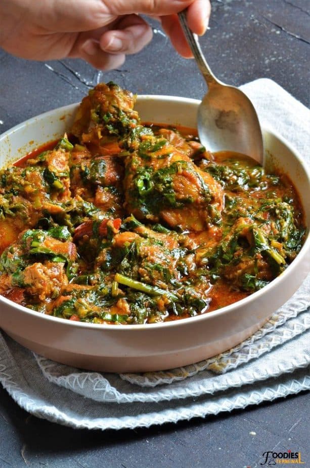 Palak chicken recipe being served with spoon