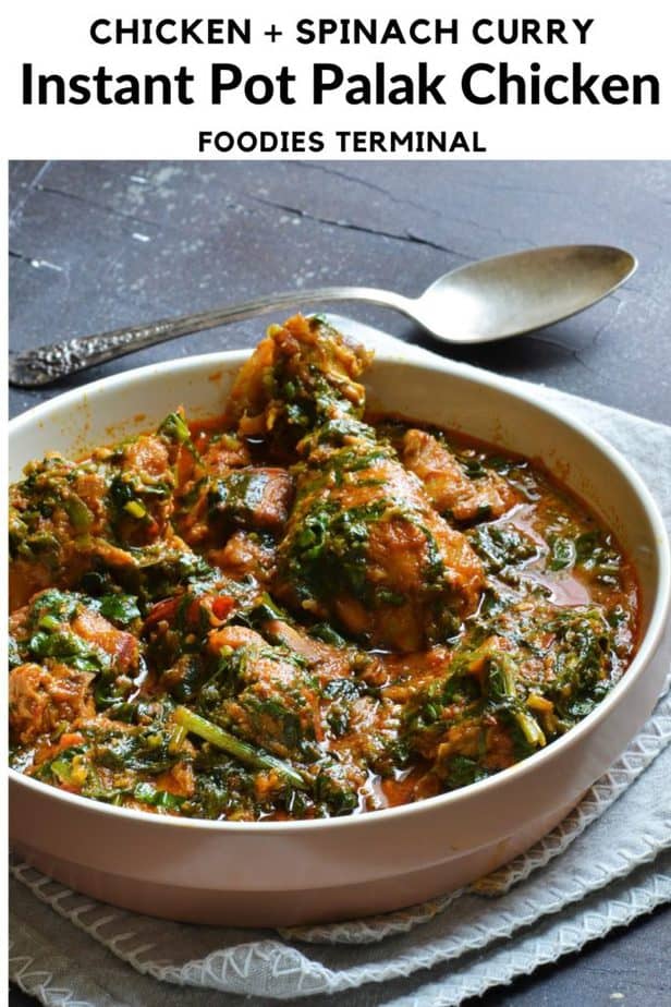 Chicken spinach curry served in a bowl beside a spoon
