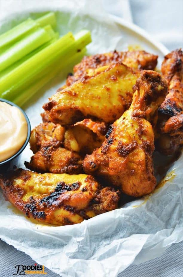 Tandoori wings served in a basket with celery sticks