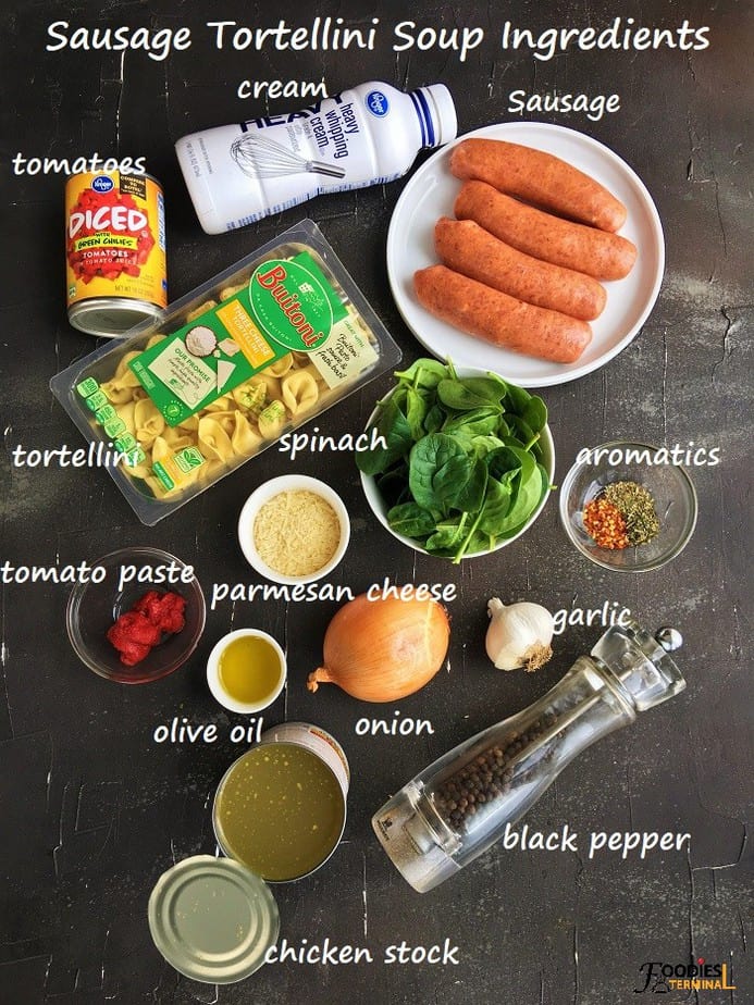 Instant pot sausage tortellini soup ingredients on a black surface
