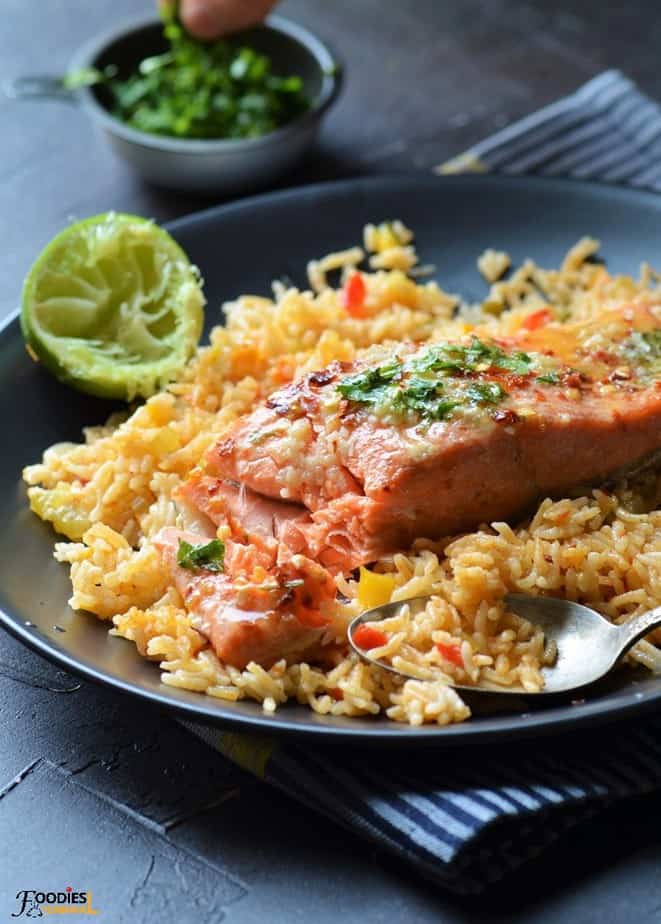 Instant Pot Salmon and Rice served on a black plate with lime