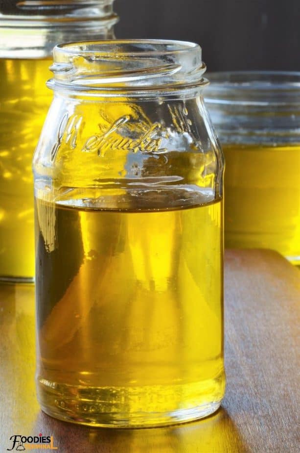 golden ghee in liquid state in a glass jar
