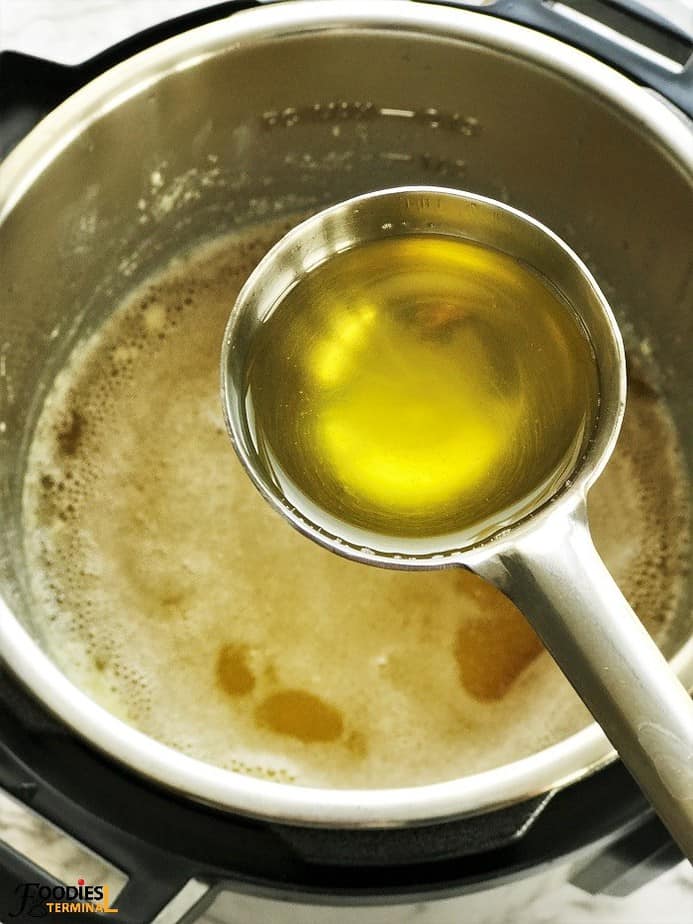 homemade ghee in instant pot picked up in a ladle