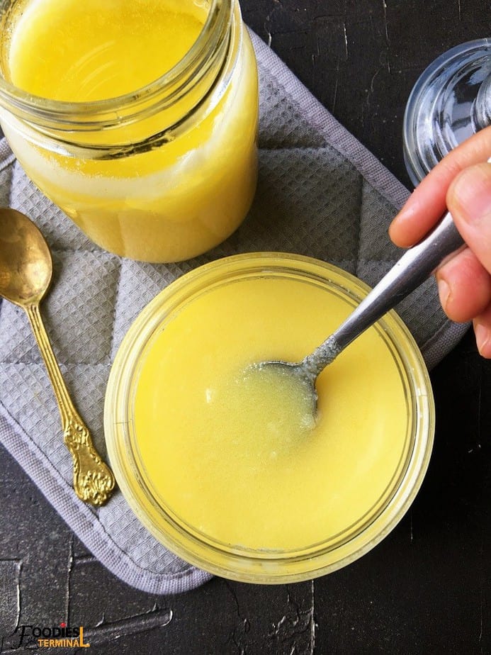 homemade ghee in semi solid state in two glass jars with spoon