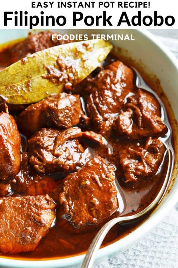 Instant Pot Pork Adobo in a bowl with spoon & a bay leaf