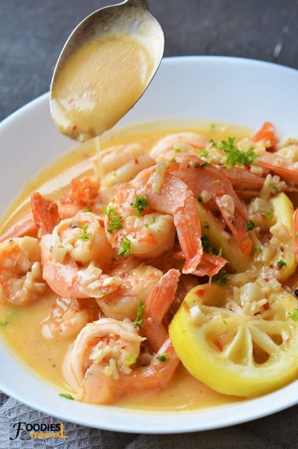 Dripping Shrimp scampi sauce from a spoon 
