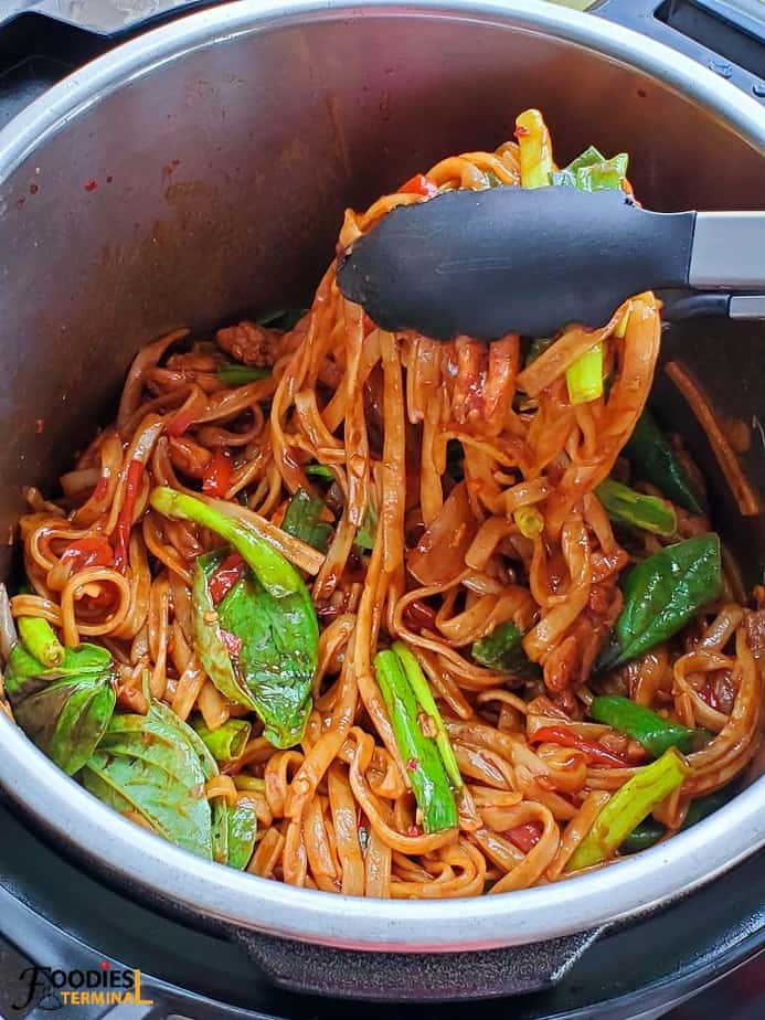 instant pot drunken noodles with chicken in instant pot lifted with tong