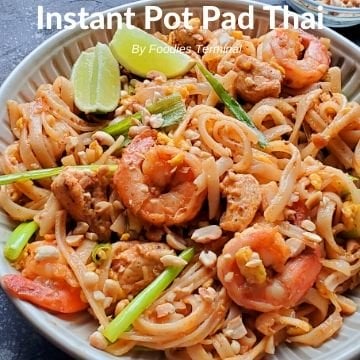 Instant Pot Pad Thai with chicken & shrimp being lifted with a tong