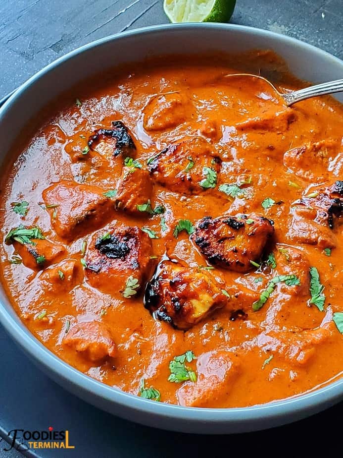 best instant pot chicken tikka masala in a grey bowl with a spoon