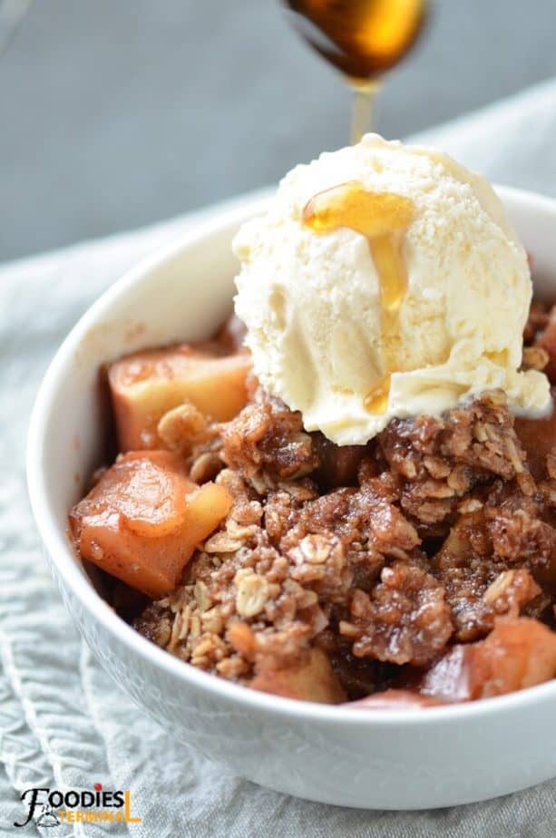Instant pot apple crisp served with vanilla ice-cream topped with syrup