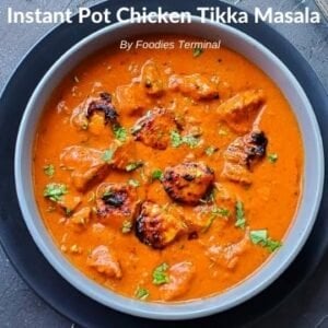 chicken tikka masala in a grey bowl kept on a black plate