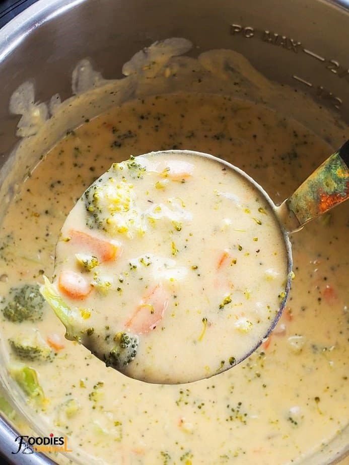instant pot panera broccoli cheddar soup in a ladle from the instant pot