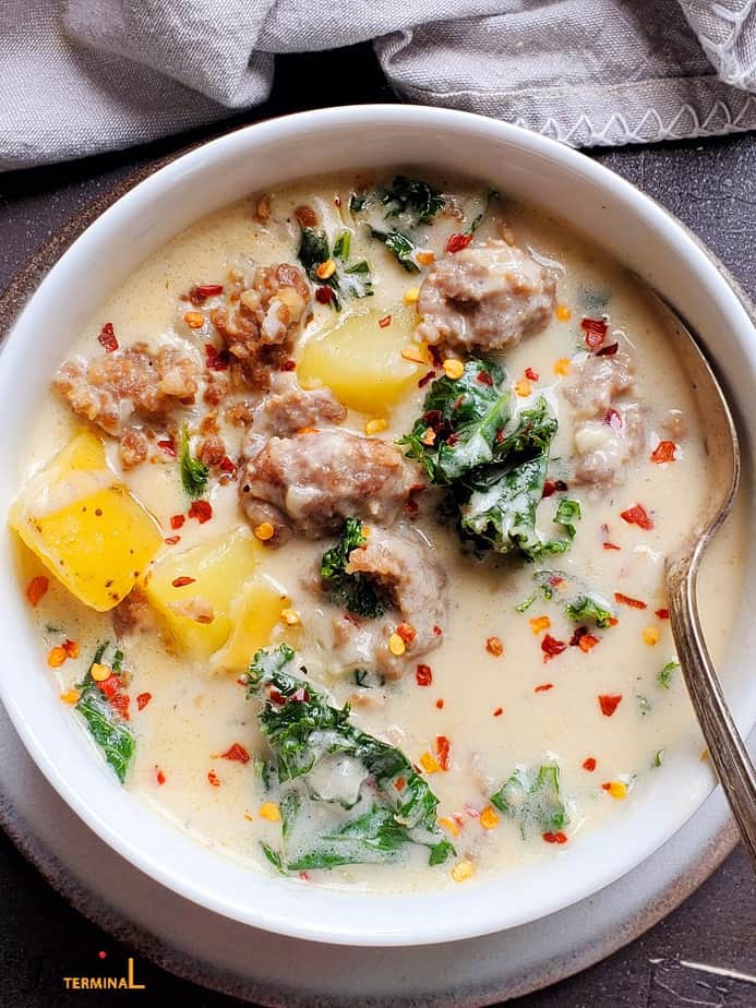 instant pot zuppa toscana soup in white bowl with silver spoon