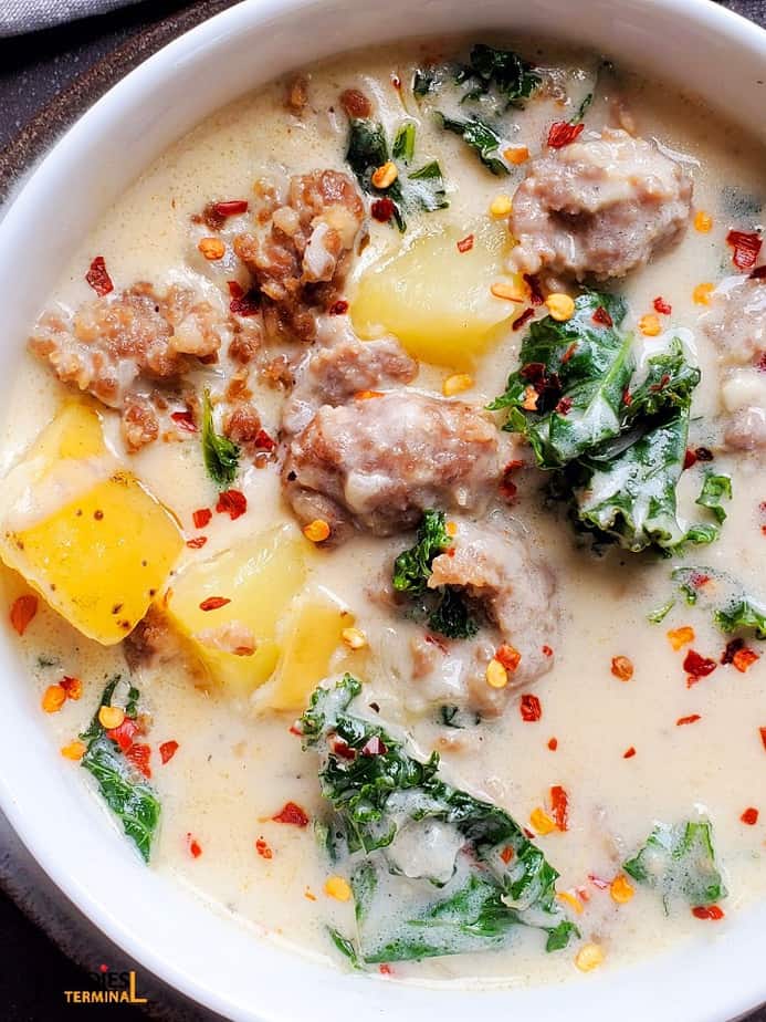 olive garden copycat instant pot zuppa toscana soup garnished with red pepper flakes