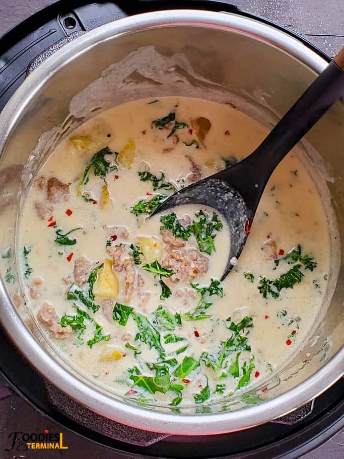 easy instant pot zuppa toscana soup in instant pot with a black ladle