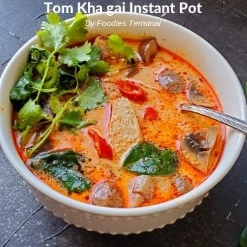 Instant Pot Tom Kha Gai in white bowl with spoon