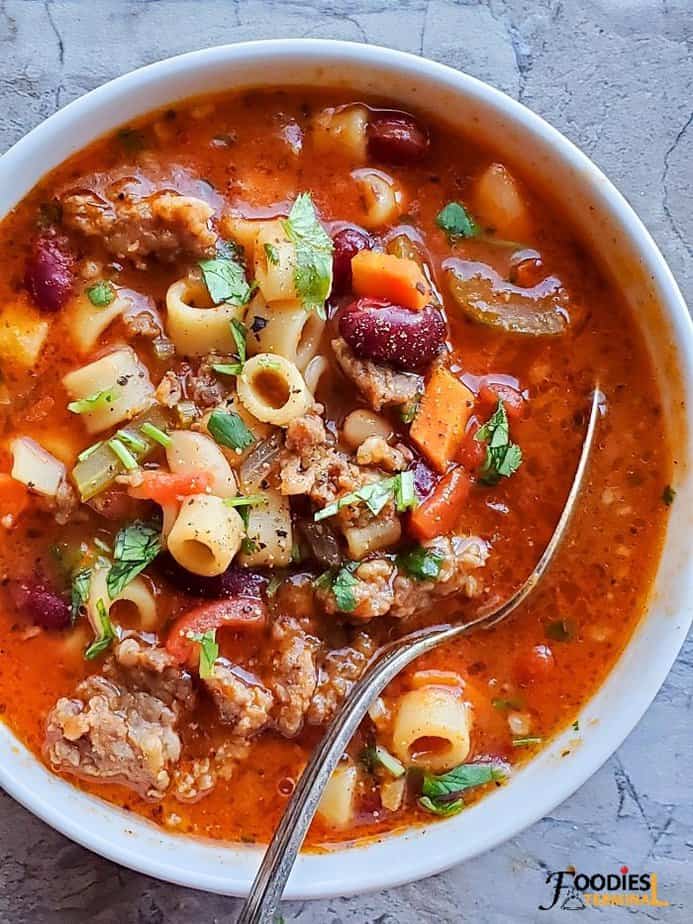 Olive Garden Copycat Pasta e Fagioli Instant Pot served in a white bowl with a spoon