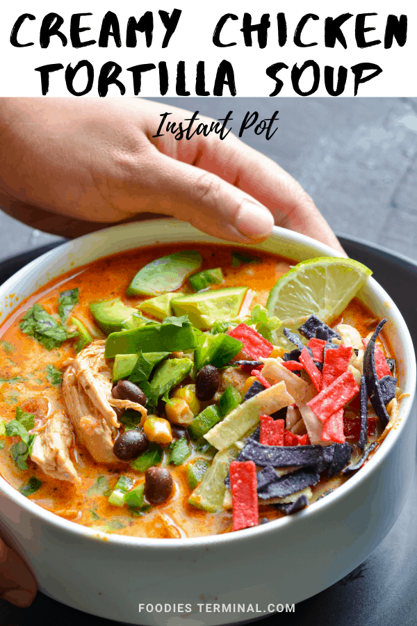 instant pot creamy chicken tortilla soup garnished with tortilla chips, jalapeno & avocado