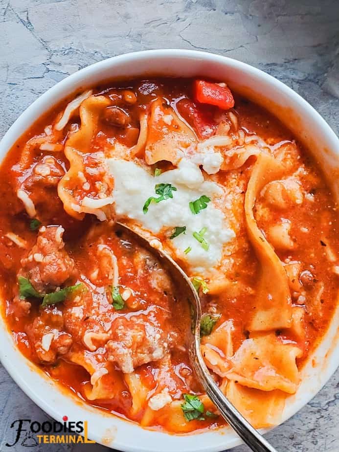 easy instant pot lasagna soup served with ricotta & mozzarella cheese in white bowl 