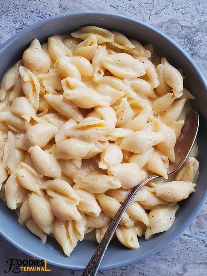 velveeta shells and cheese instant pot recipe served in a grey bowl with a spoon
