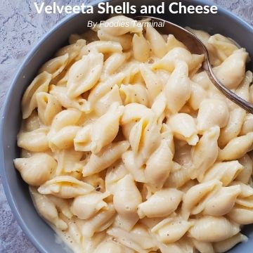 Velveeta shells and cheese in a grey bowl with a spoon