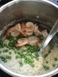 peas and shrimp in the pot on top of risotto rice