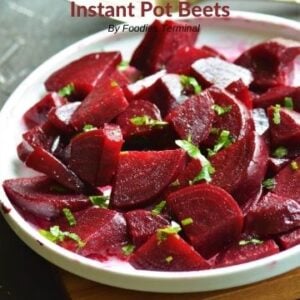 Pressure cooked diced beets garnished with chopped parsley and served on a white plate