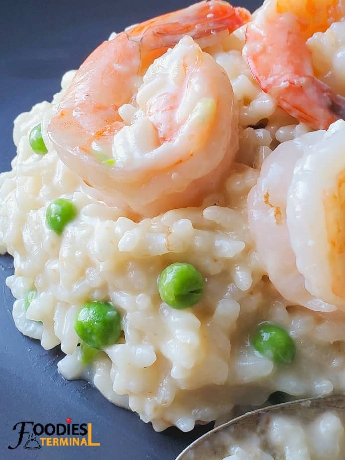 instant pot shrimp and pea risotto so creamy on a black plate