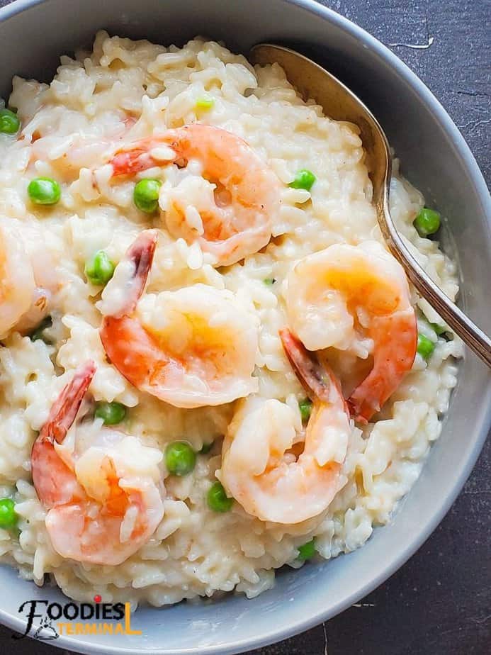 shrimp risotto instant pot recipe in a grey bowl with spoon
