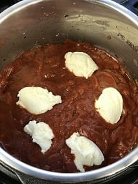 layering ziti sauce and ricotta