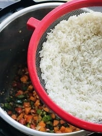 rinsed basmati rice in a metal strainer
