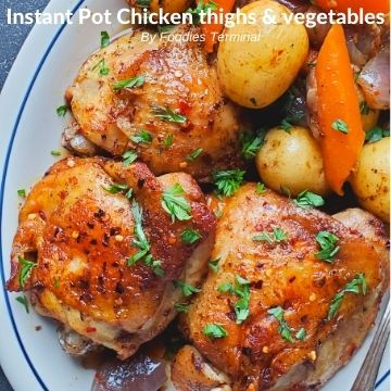 pressure cooked skin on chicken thighs, baby potatoes, carrots in a white plate garnished with chopped parsley