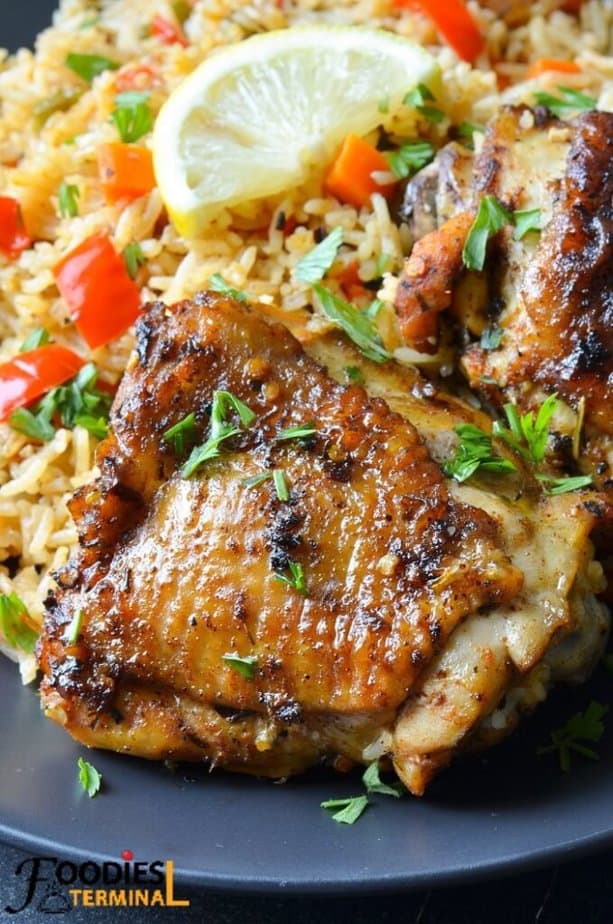 Instant pot chicken thighs and white rice in a black plate