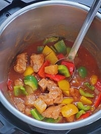 sweet and sour pork inside instant pot with a steel ladle